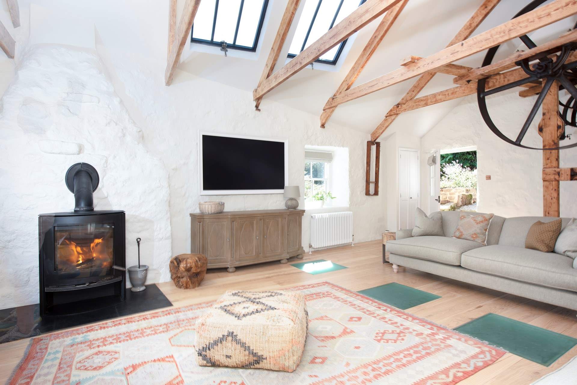 A characterful room with exposed beams and a huge wood-burner.