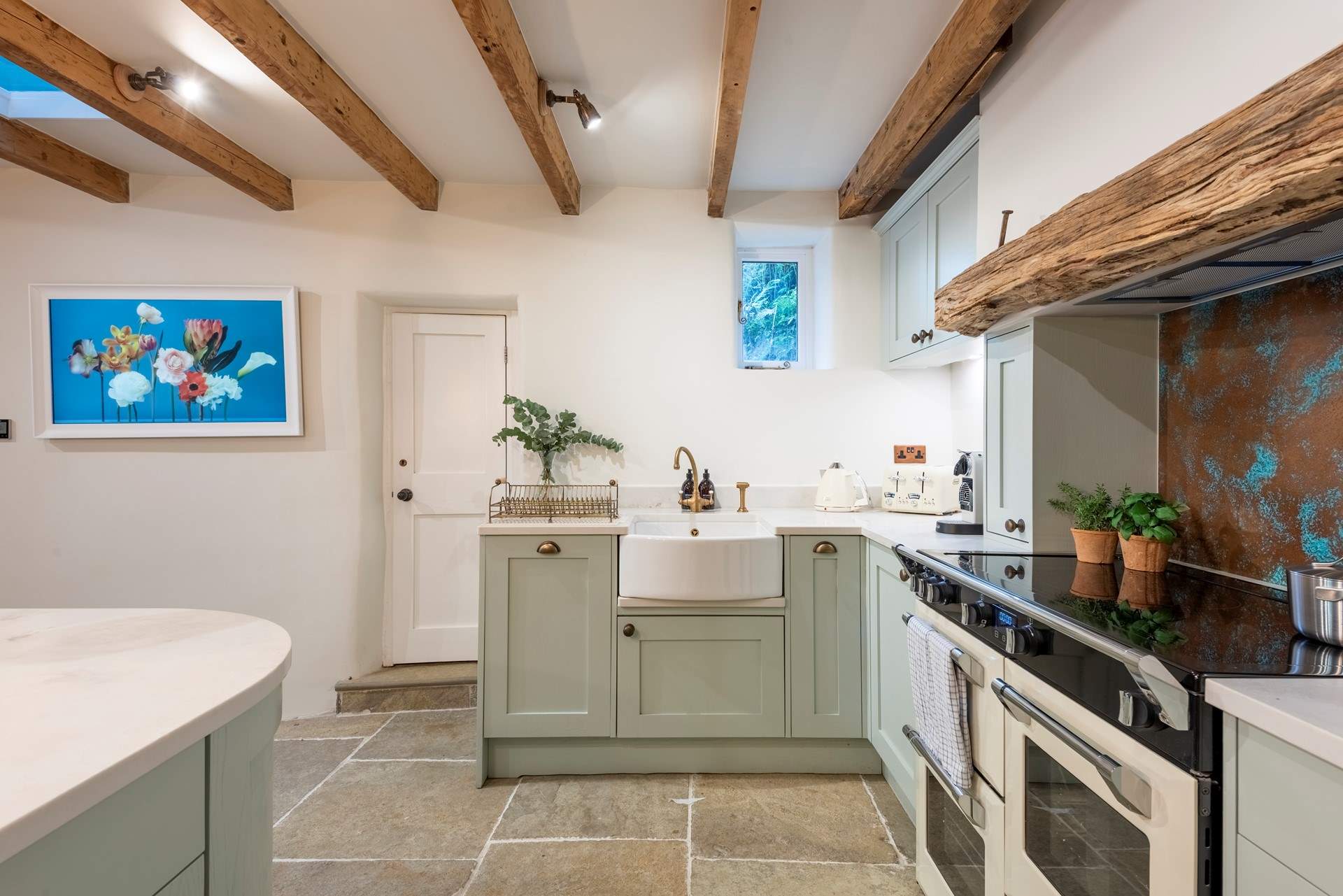 A picture-framed Smart TV is displayed on the wall and there is also a small pantry.
