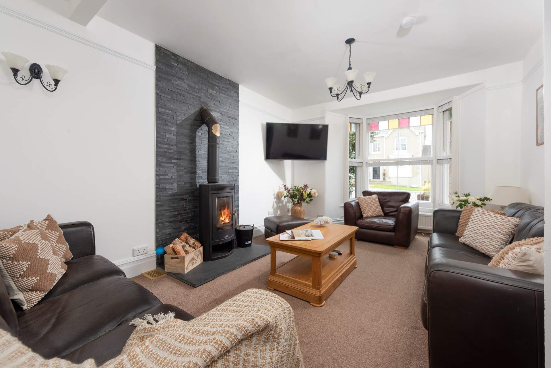 Light fills the cosy sitting-room from the original bay window.