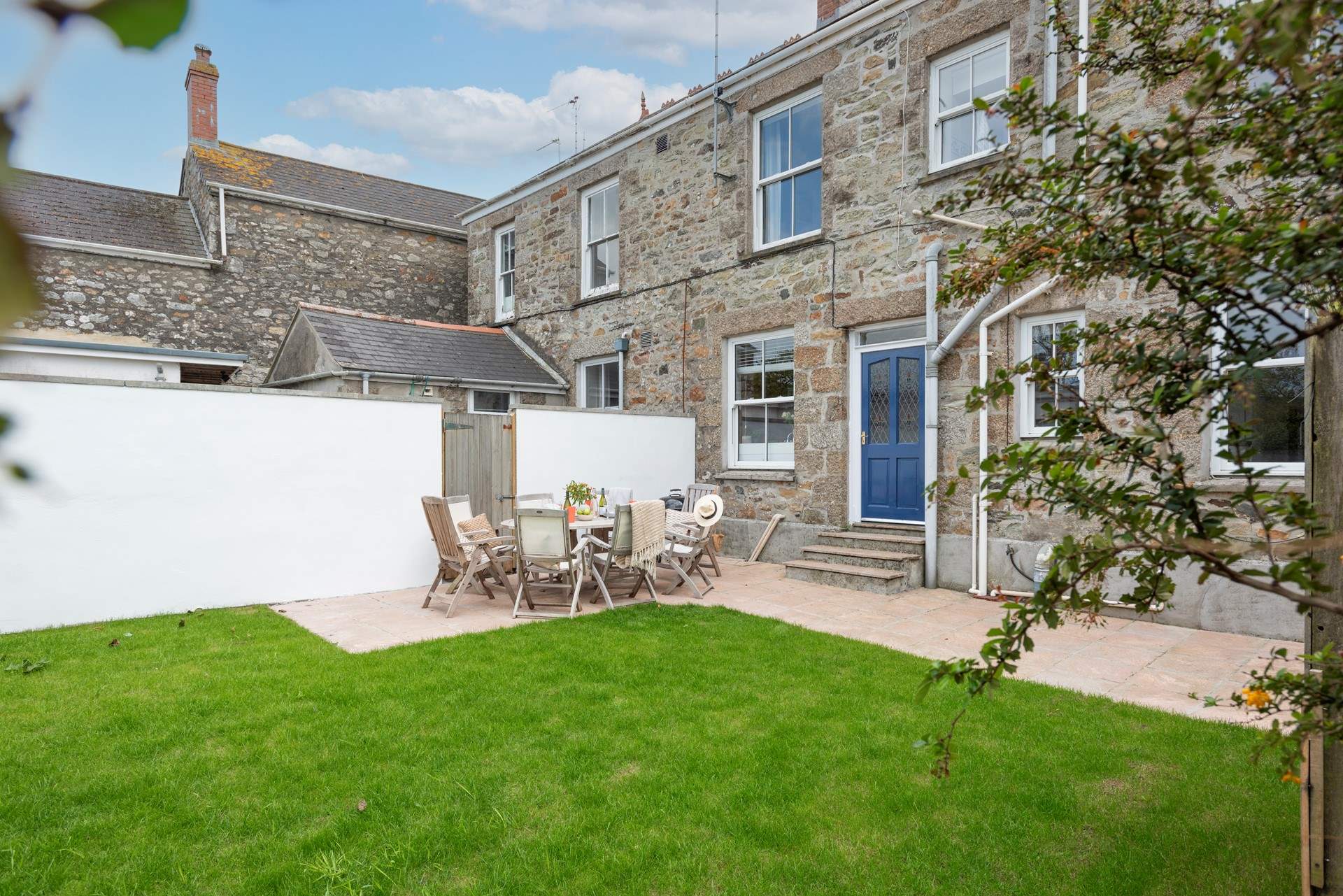 Dine outdoors in the garden at the back of the house.