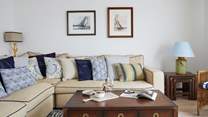 This beautiful light and bright sitting-room has comfy sofas for you to relax in after a busy day exploring the island.