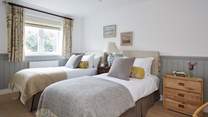 The first floor twin bedroom is located to the rear of the property and overlooks the outside space.
