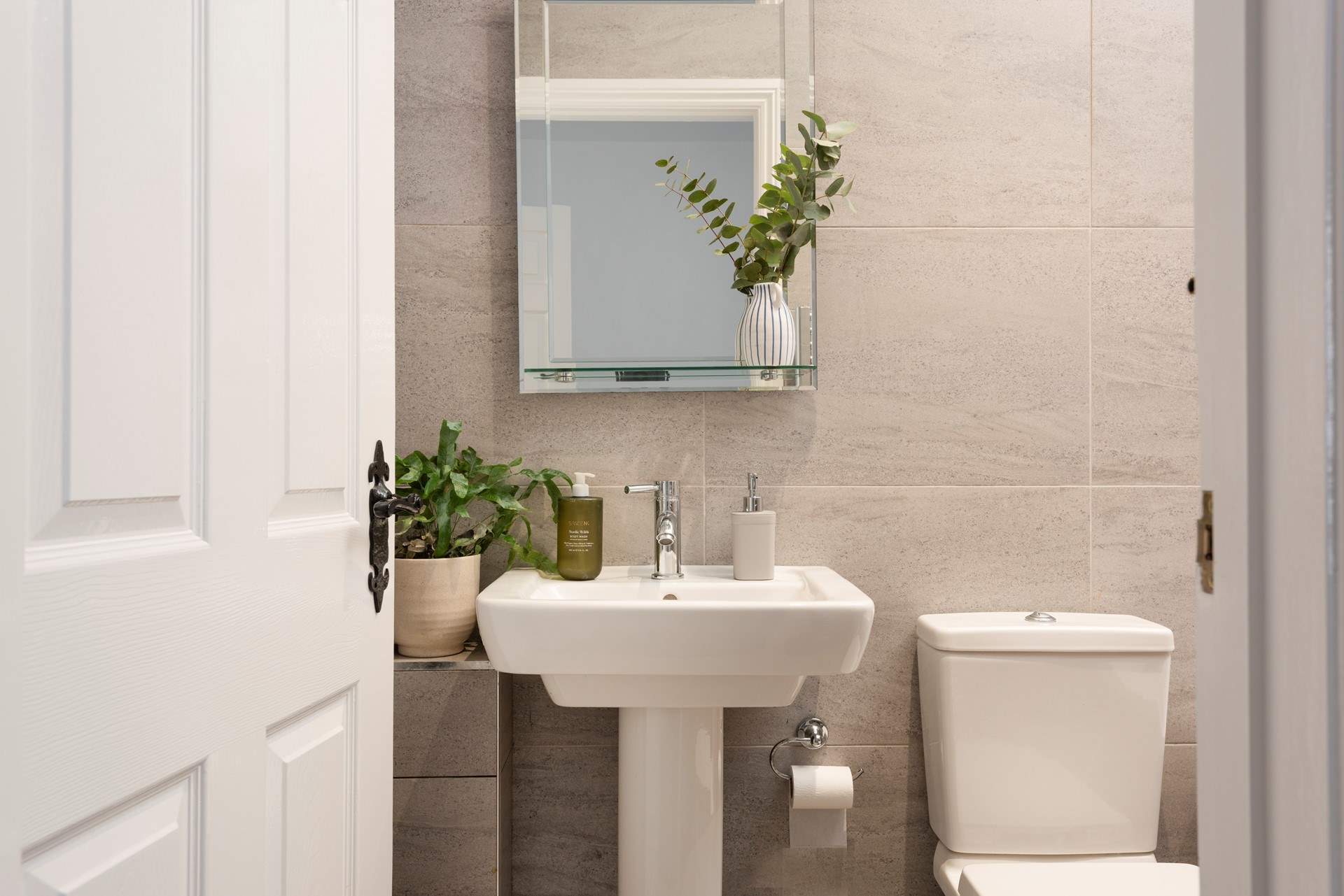 The en suite bathroom is sleek and modern.