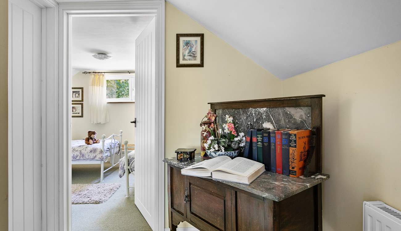 Head across the hallway to the twin bedroom passing the bathroom.