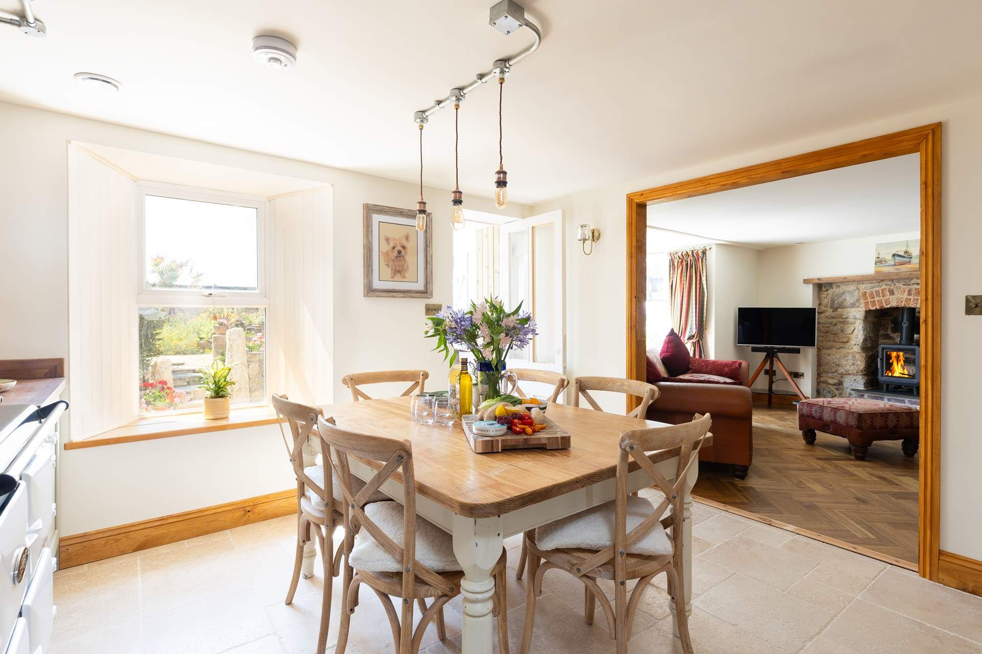 The open flow leads through to the first beautifully cosy sitting-room, perfect for quiet evenings in.