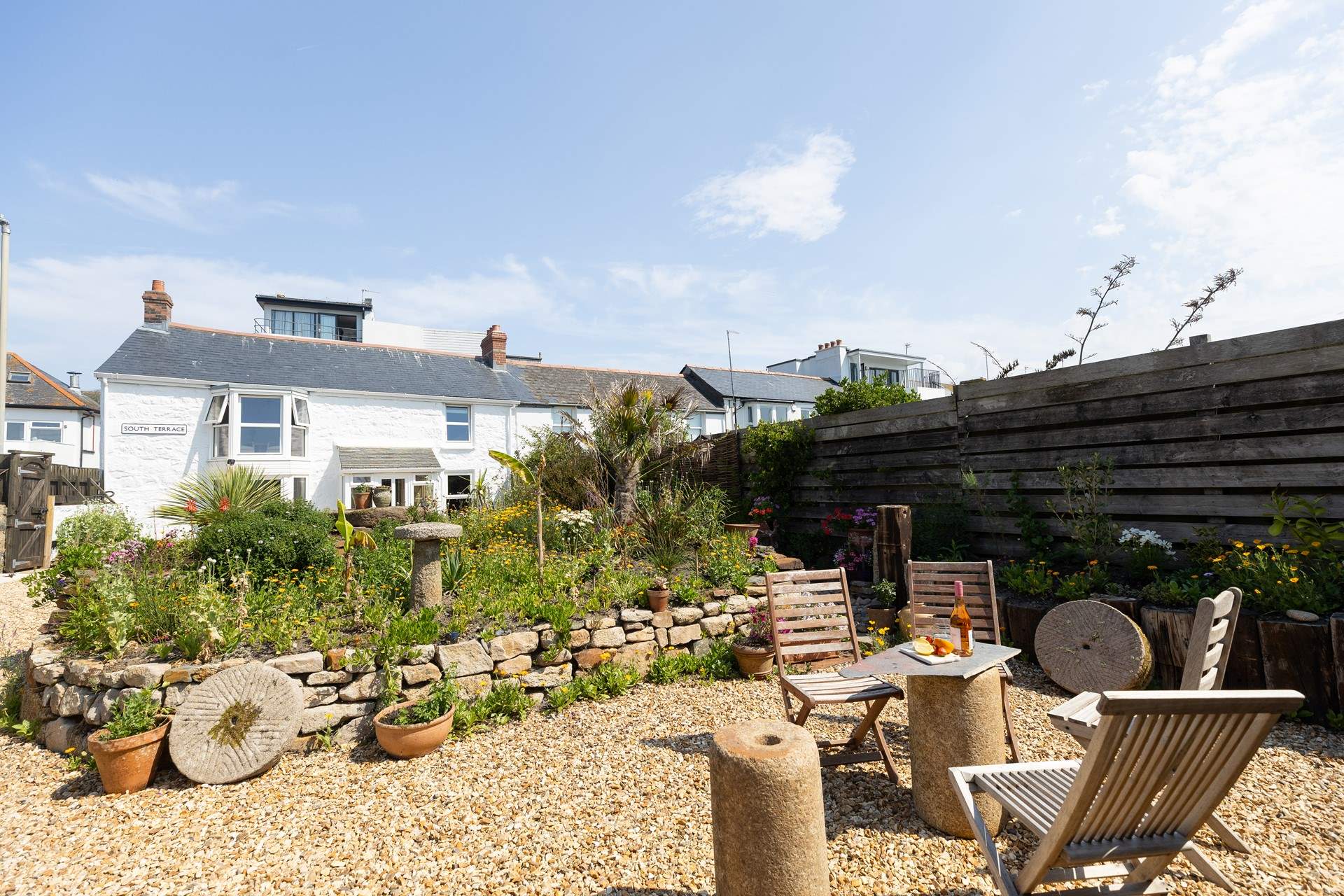 A private flower filled garden, the perfect spot to relax and breathe in the fresh sea air.
