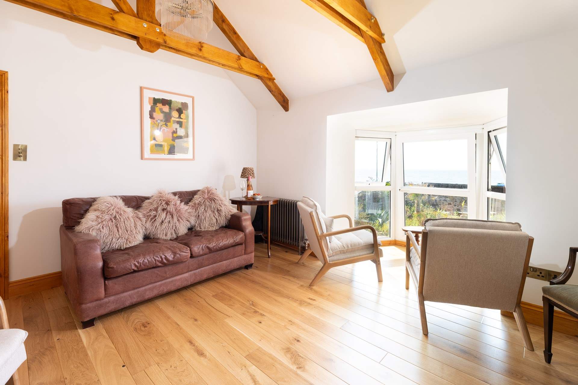 The upstairs sitting-room with captivating sea views, passing seagulls and an ever-changing frame in front of you.