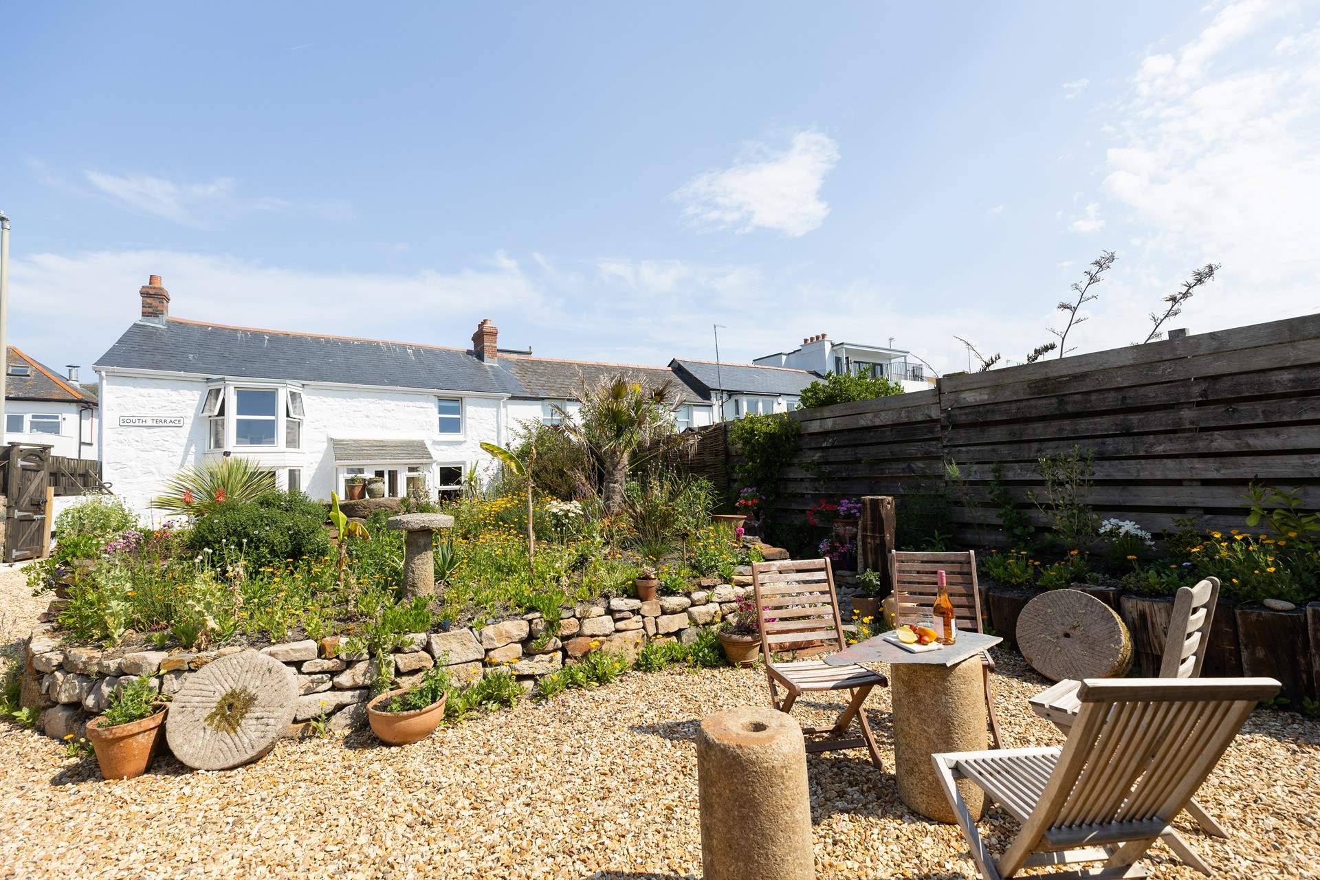 A private flower filled garden, the perfect spot to relax and breathe in the fresh sea air.