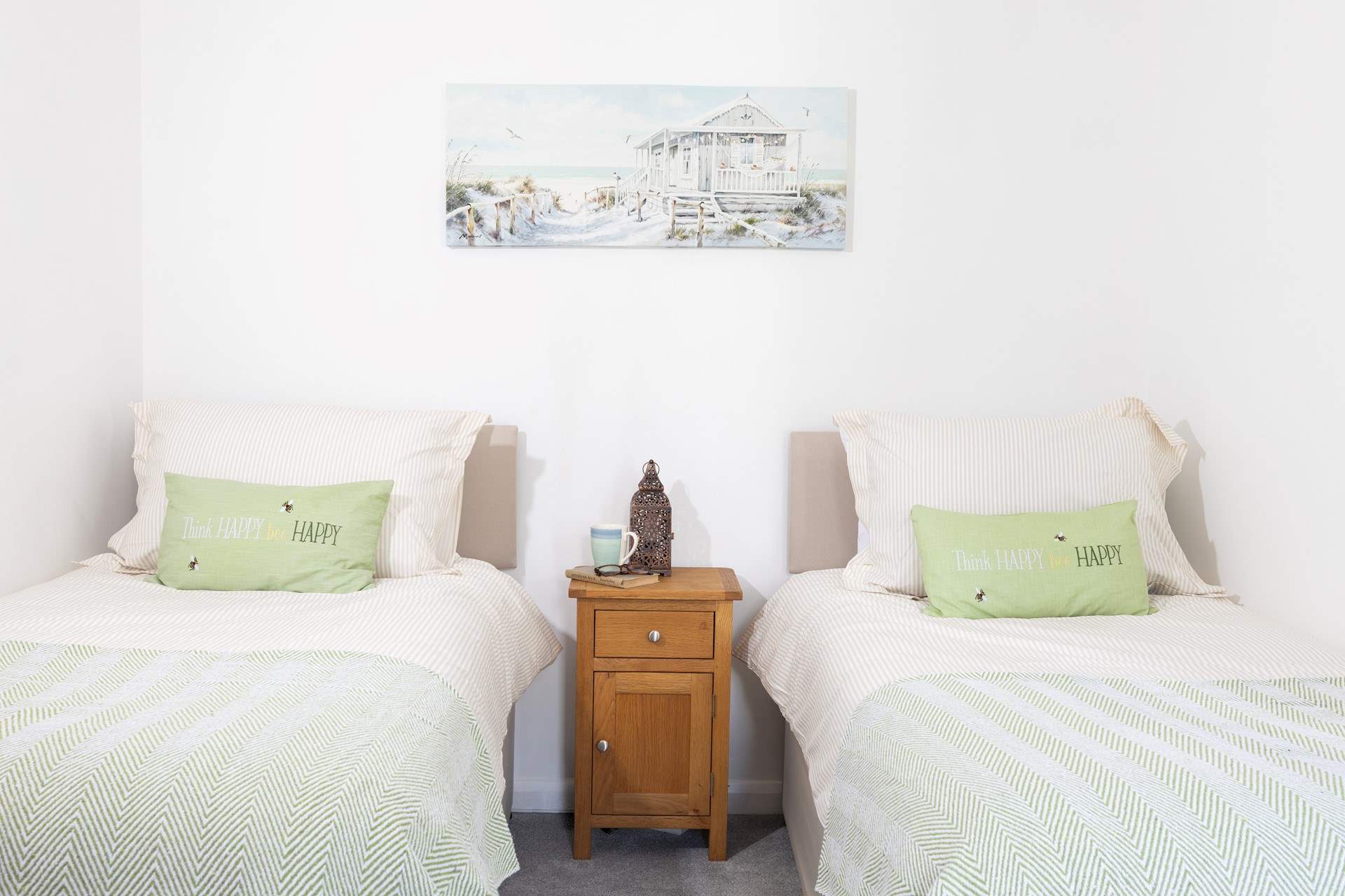The cute twin bedroom dressed in warming green tones. 