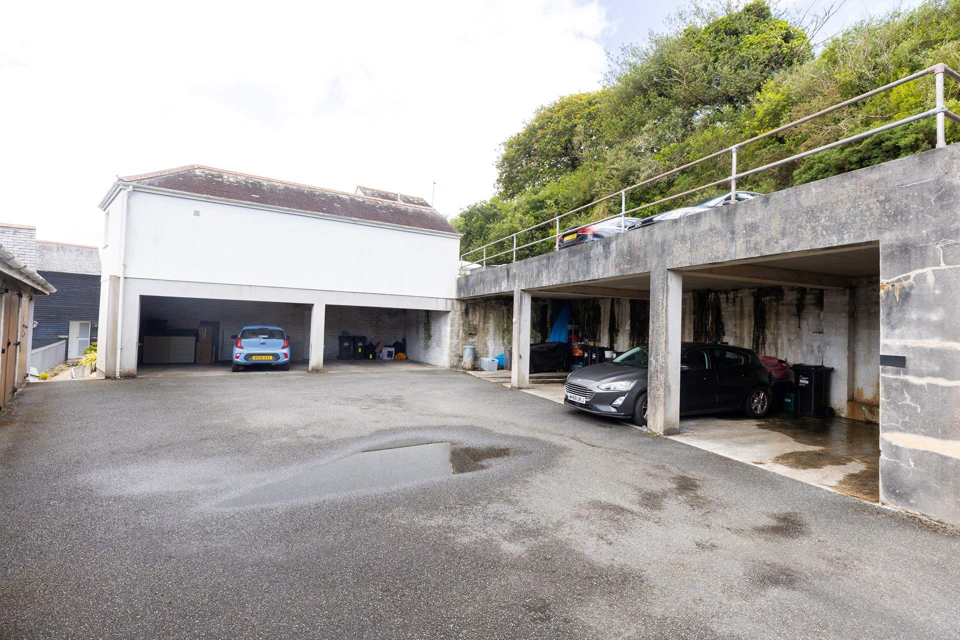The car parking space for Riverside is the empty garage on the right. The property is found 50 yards from the parking space, and down 39 steps. 