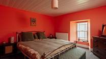 The sea facing king bedroom on the first floor has warming hues. 