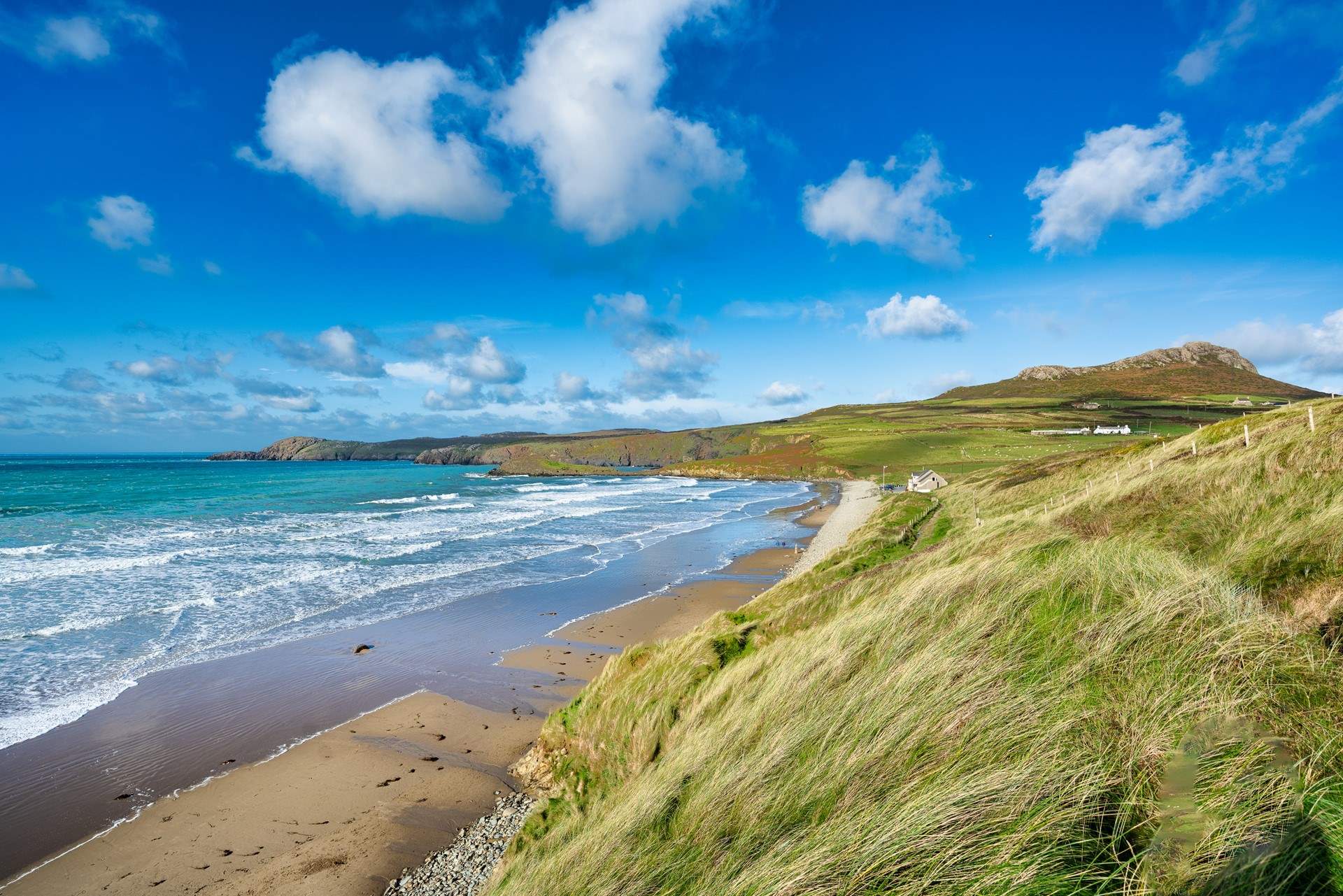 The rolling surf of glorious Whitesands Beach near St. David's looking out to Ramsey Island. Popular with both surfers and families. Try lunch and delicious icecreams in the beach cafe. 