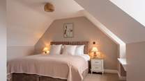 Soft earthy tones welcome you to one of six elegant bedrooms.