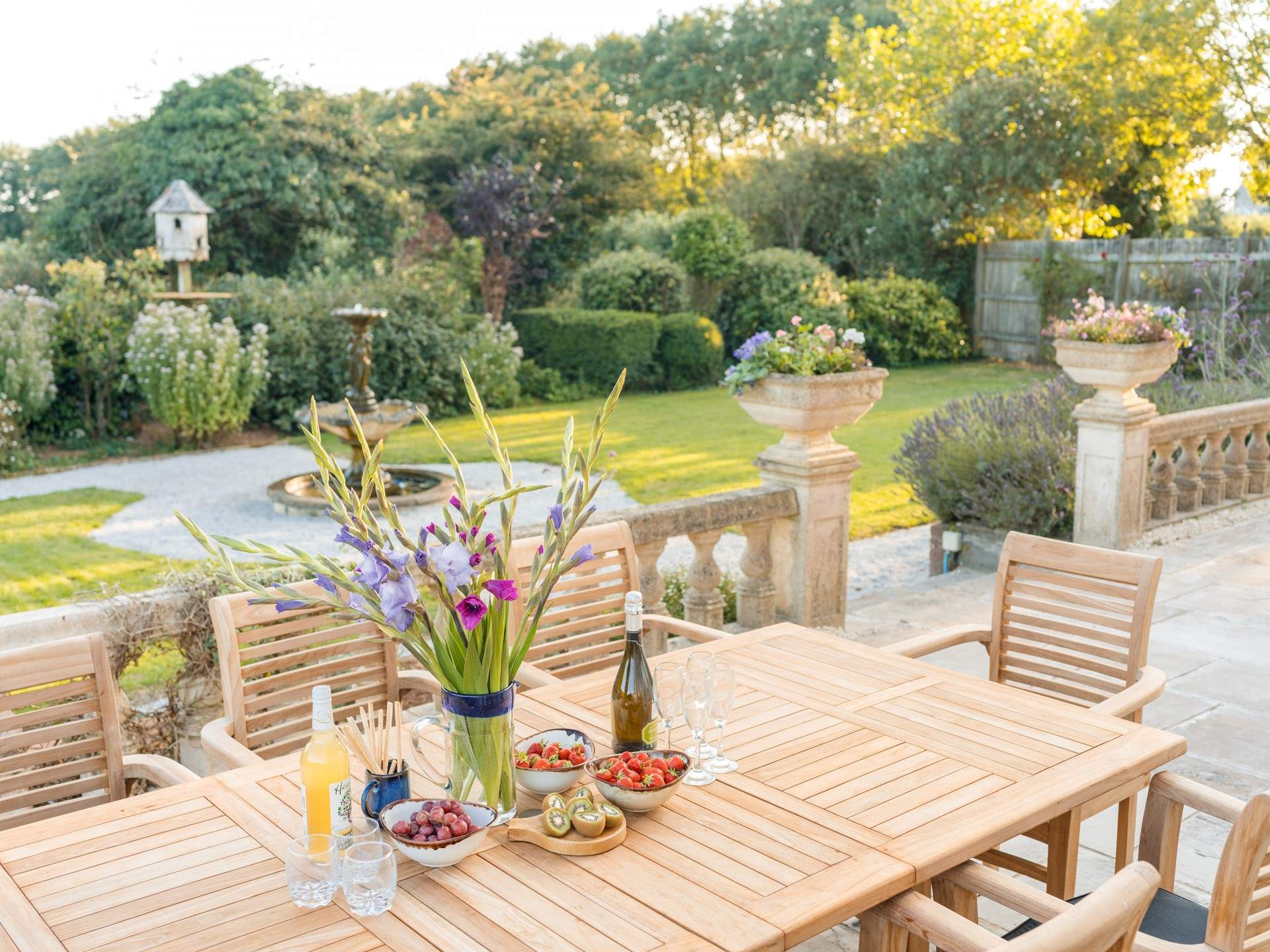 Dine al fresco on the spacious front terrace overlooking the fountain.