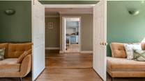 Cross the polished wooden floors into the kitchen.