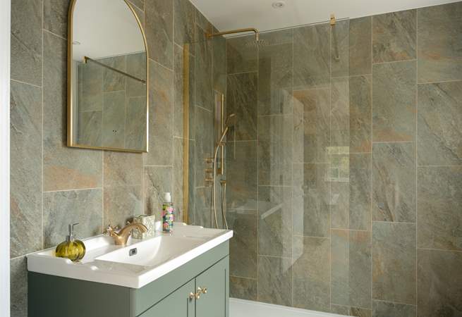Tiled from floor to ceiling, the en suite is both practical and elegant.