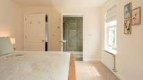 A luxurious bedroom with a super-king bed and its own en suite shower-room with garden views.