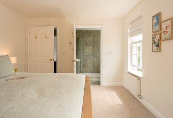 A luxurious bedroom with a super-king bed and its own en suite shower-room with garden views.