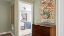Thoughtfully displayed artwork welcomes you to the bedrooms.