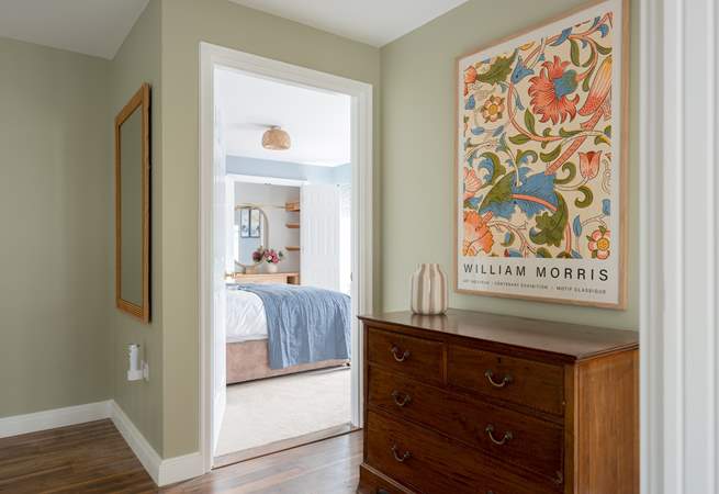 Thoughtfully displayed artwork welcomes you to the bedrooms.