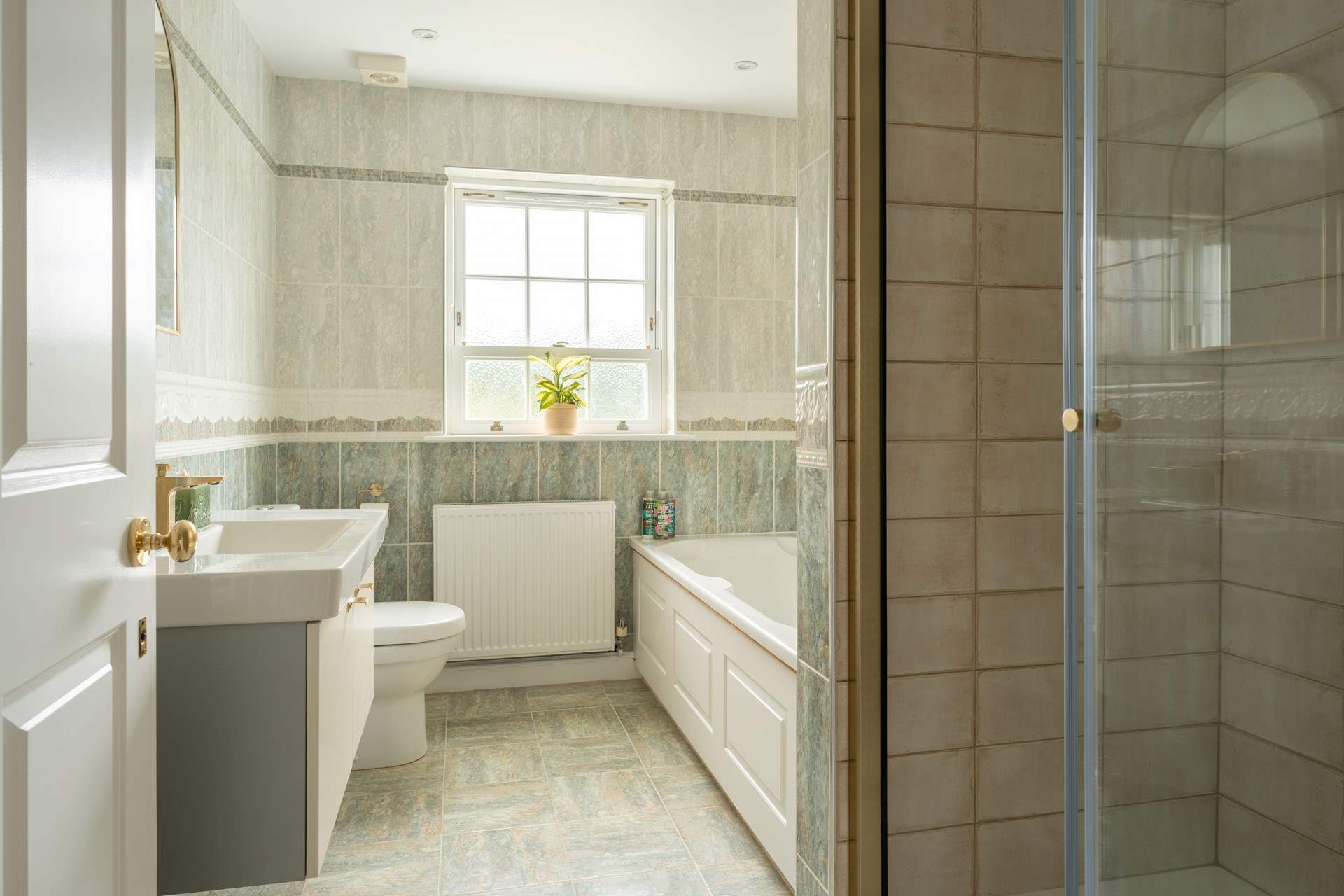 The family bathroom with bath and separate luxury shower on the first floor.