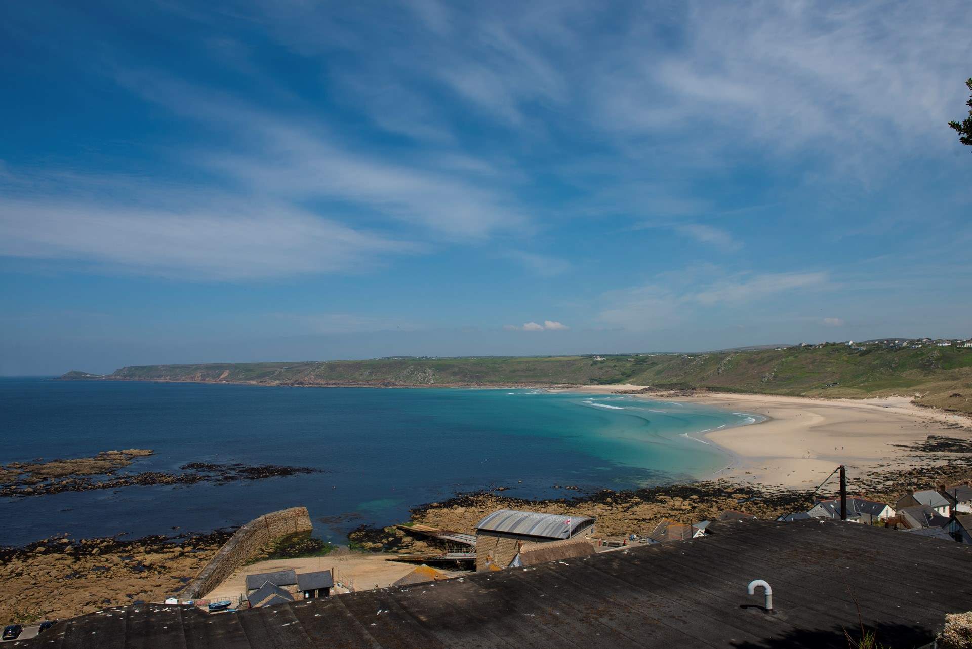 There are so many beaches to visit in west Cornwall here is the long stretch of sand at Sennen Cove.