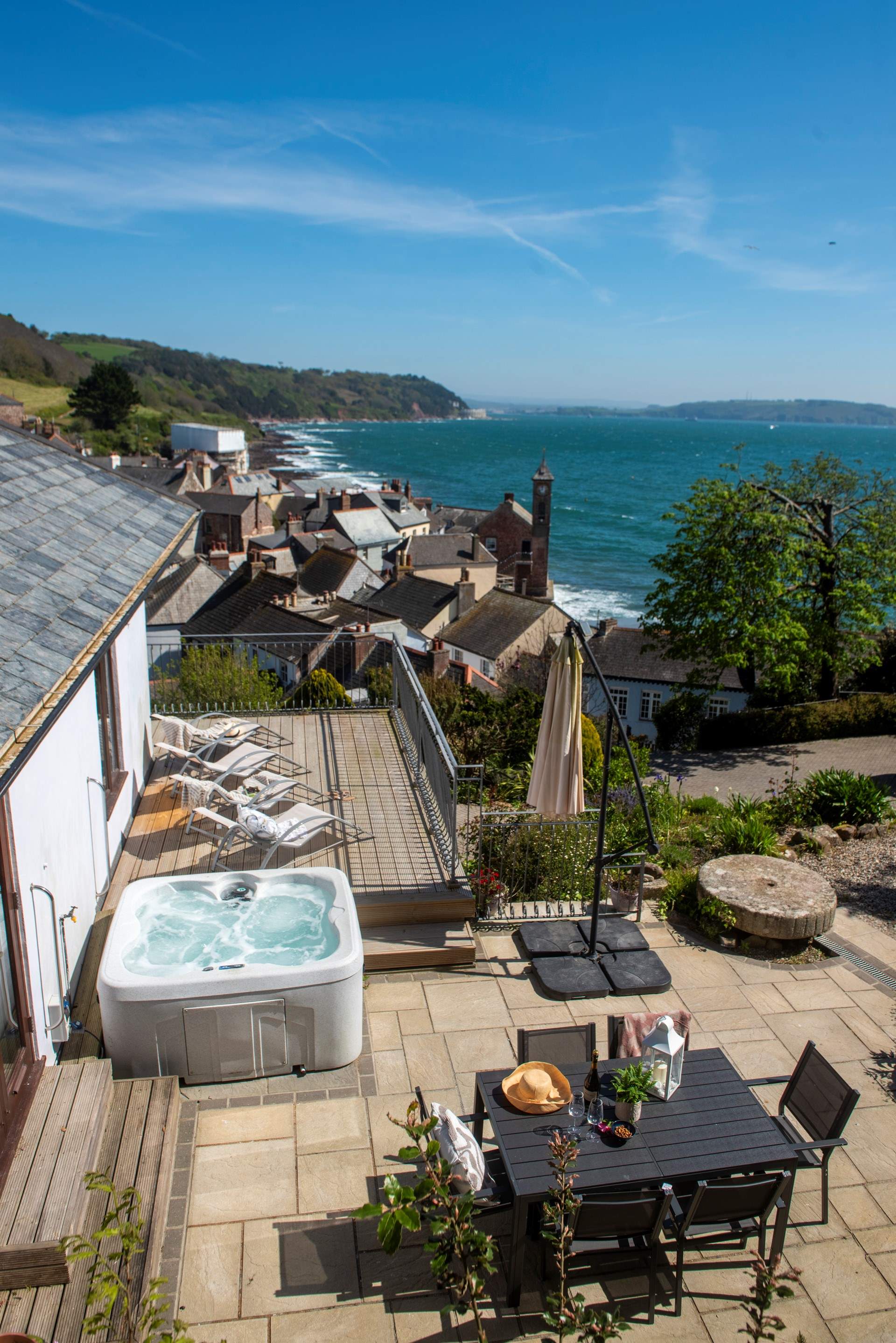 Double doors lead from bedroom 4 out to the side terrace with the hot tub.
