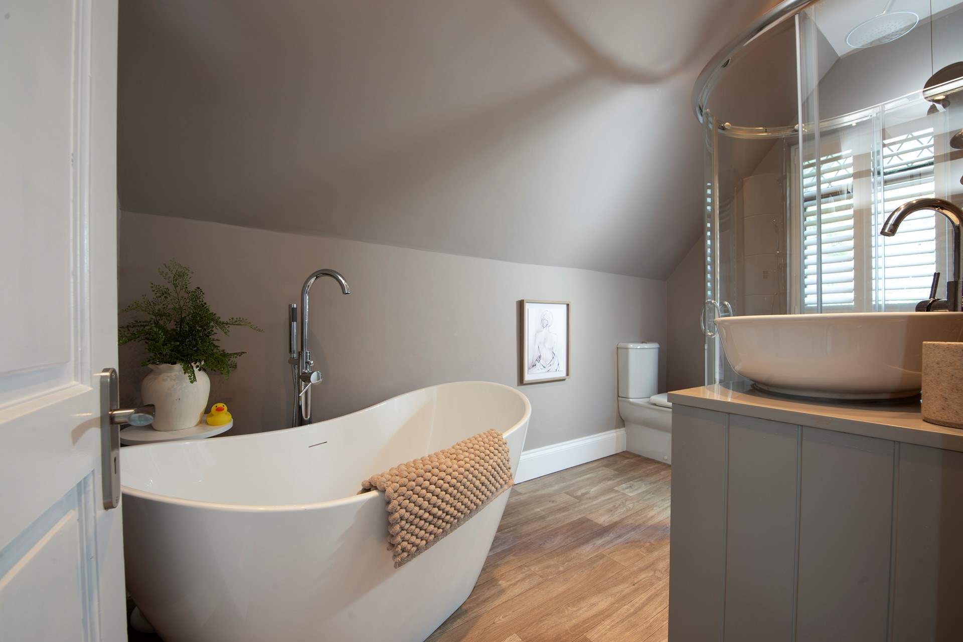 The family bathroom sits on the second floor with its free standing bath and .....