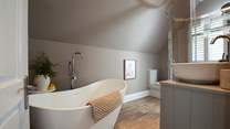 The family bathroom sits on the second floor with its free-standing bath and .....
