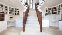 The grand entrance hall creates a warm welcome especially for your four-legged friends .