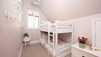 The charming bunk bedded room will delight the younger members of the group.