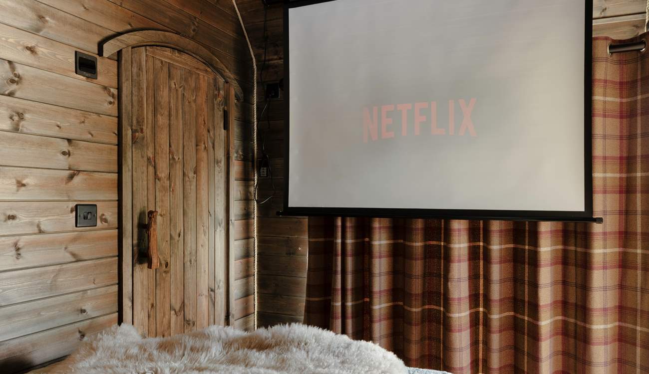 The projector transforms cosy nights in into the perfect cabin cinema experience.