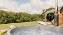Soak away your worries in the bubbling wood-fired hot tub.