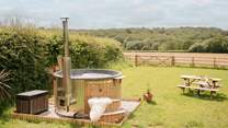 Enjoy the steaming hot tub with calming countryside in every direction.
