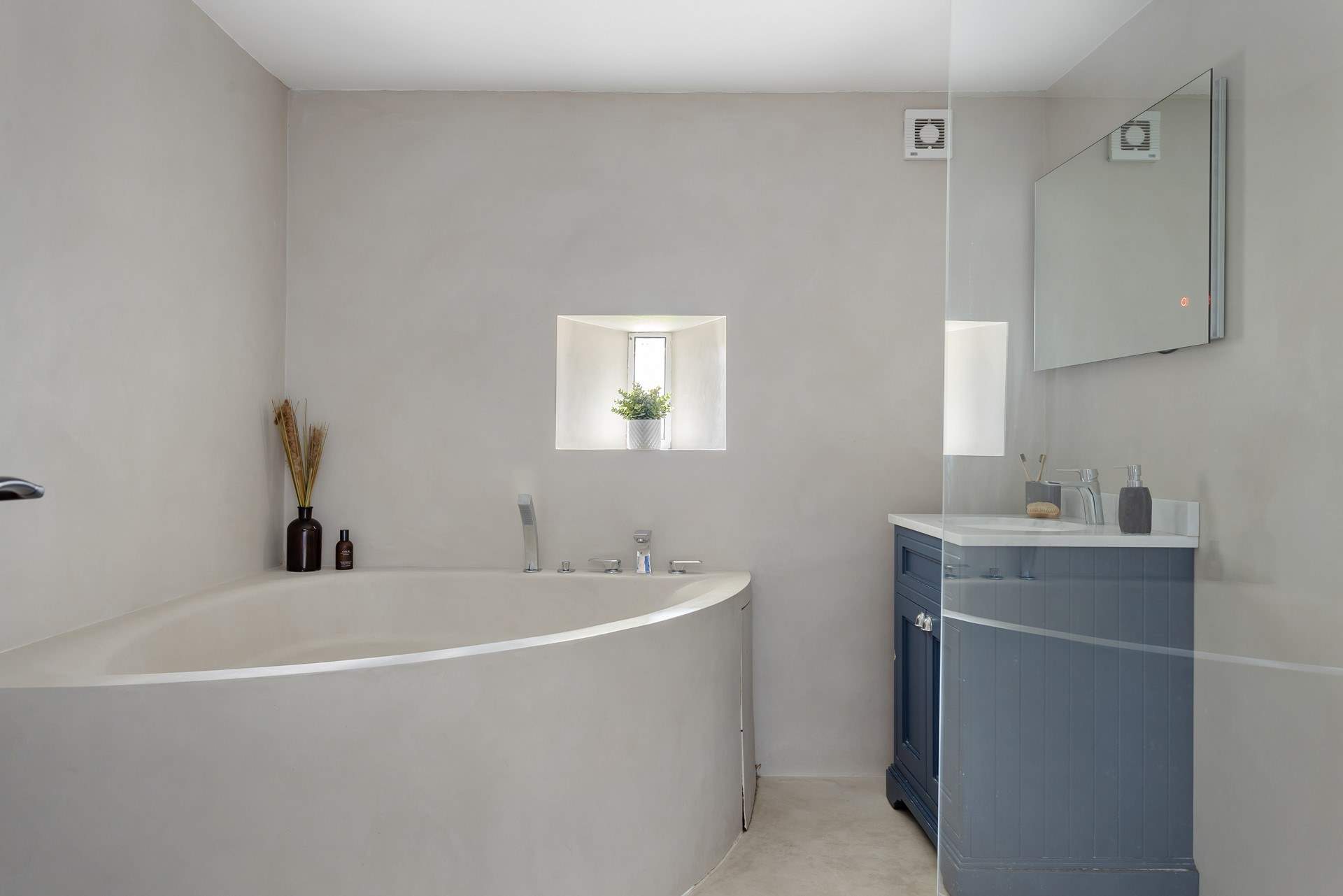 The luxurious family bathroom with a stunning corner bath and large shower.