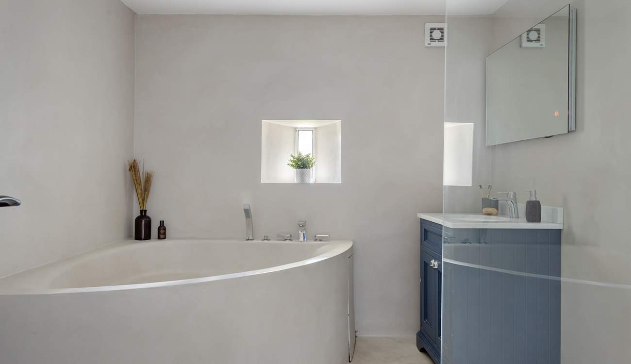 The luxurious family bathroom with a stunning corner bath and large shower.