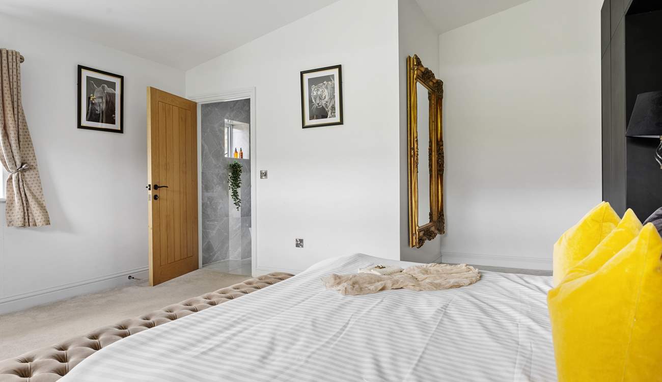 Incredibly spacious, the bedroom also boasts an en suite shower-room.