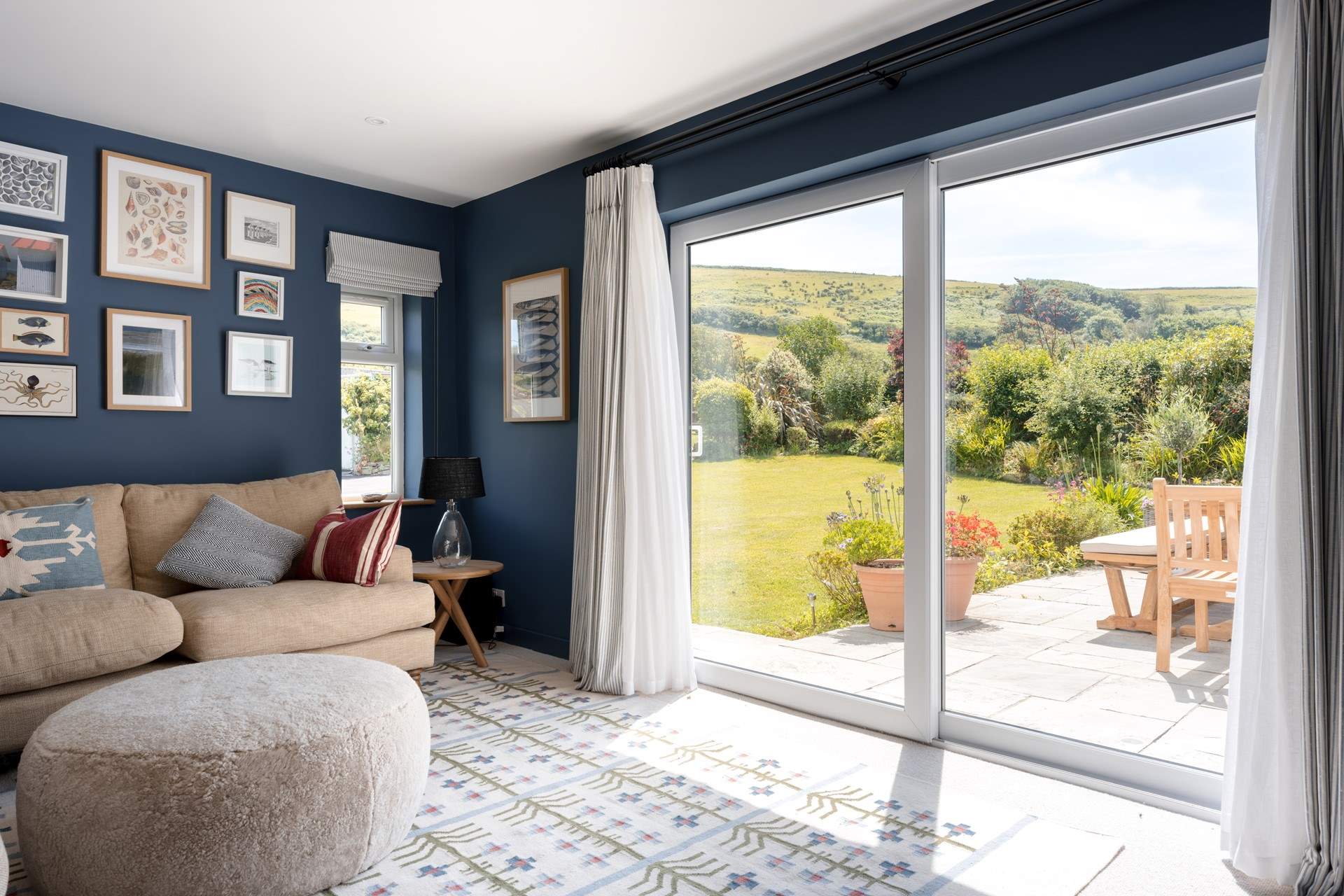The patio doors open on to another side patio where you will find a beautiful dining-table, loungers and the surf pavilion with two brass outdoor showers. 
