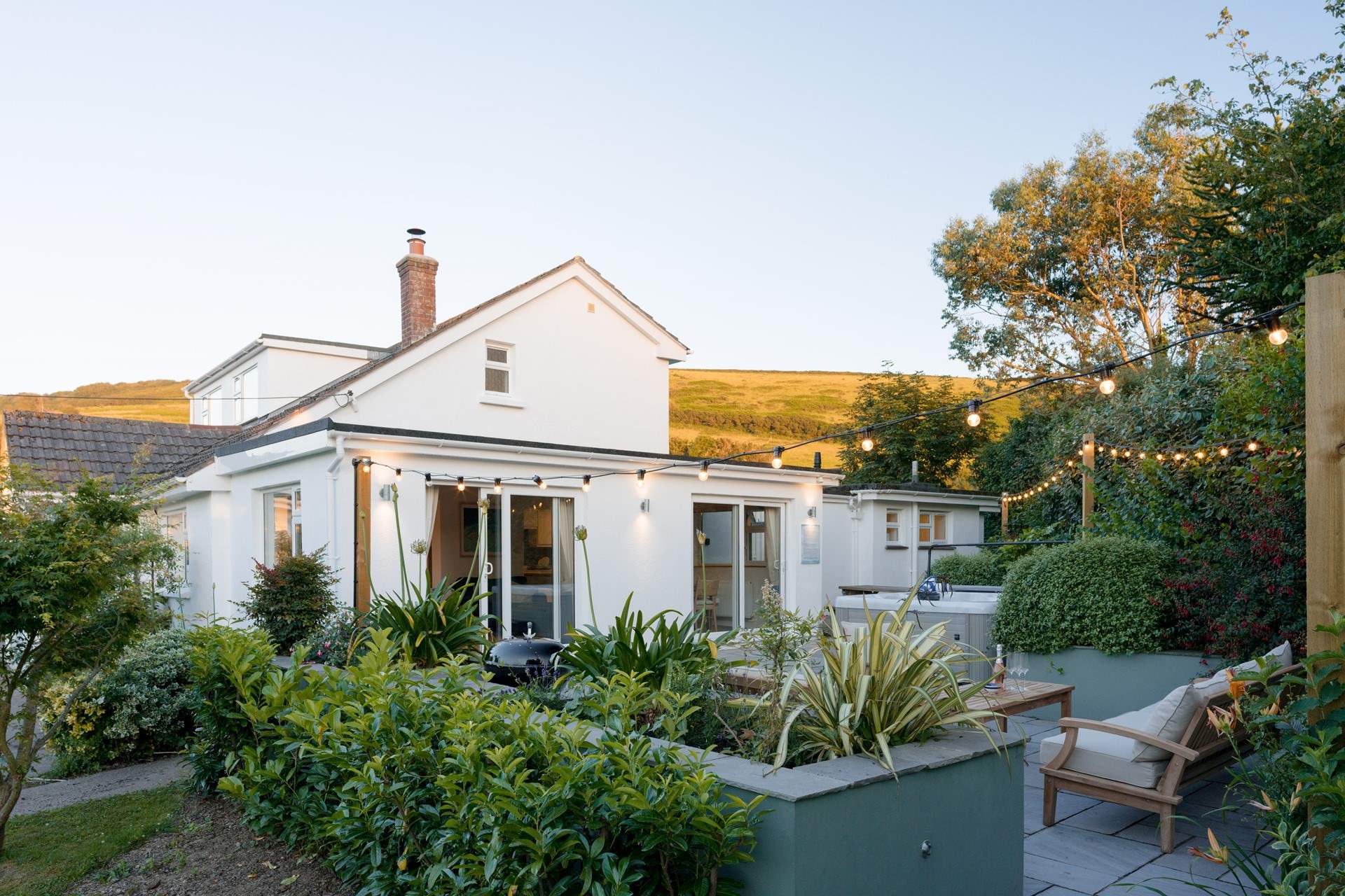 The open plan living-area can be found through the double patio doors.  As the sun sets it's time to switch on the festoon lights and the hot tub bubbles.