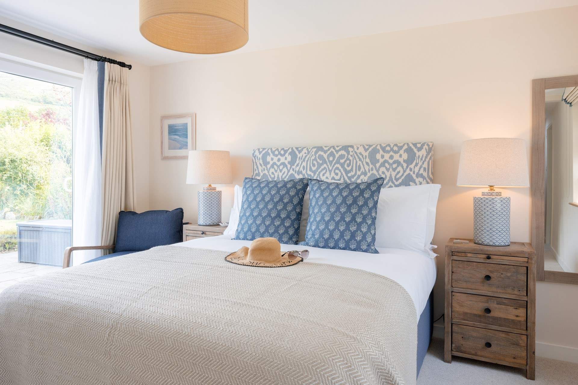 Bedroom 3 can be found at the end of the hallway with a comfortable king-size bed and an en suite shower-room.  You also have the benefit of patio doors that open out to the garden.  