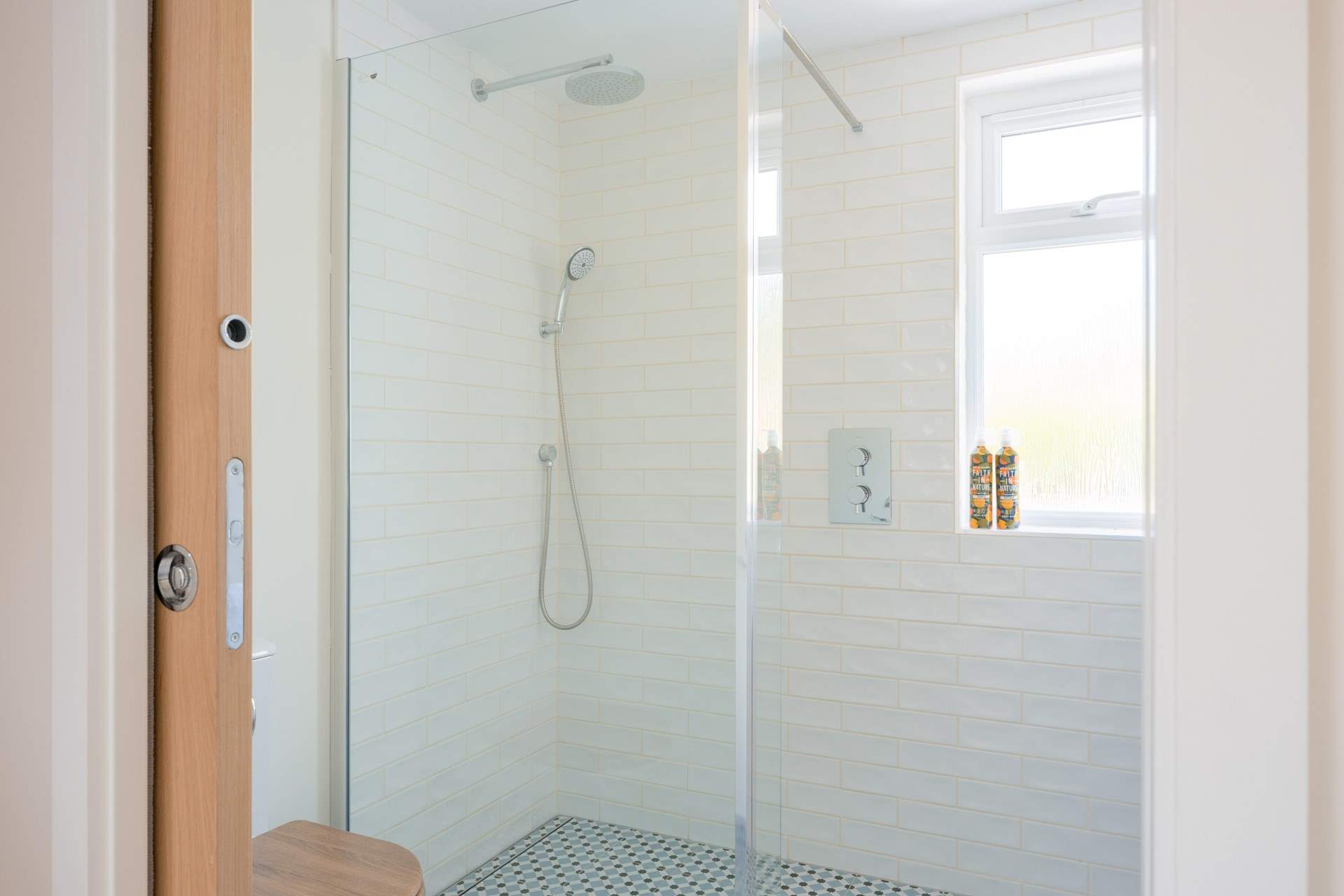 The large walk-in waterfall shower is spacious.