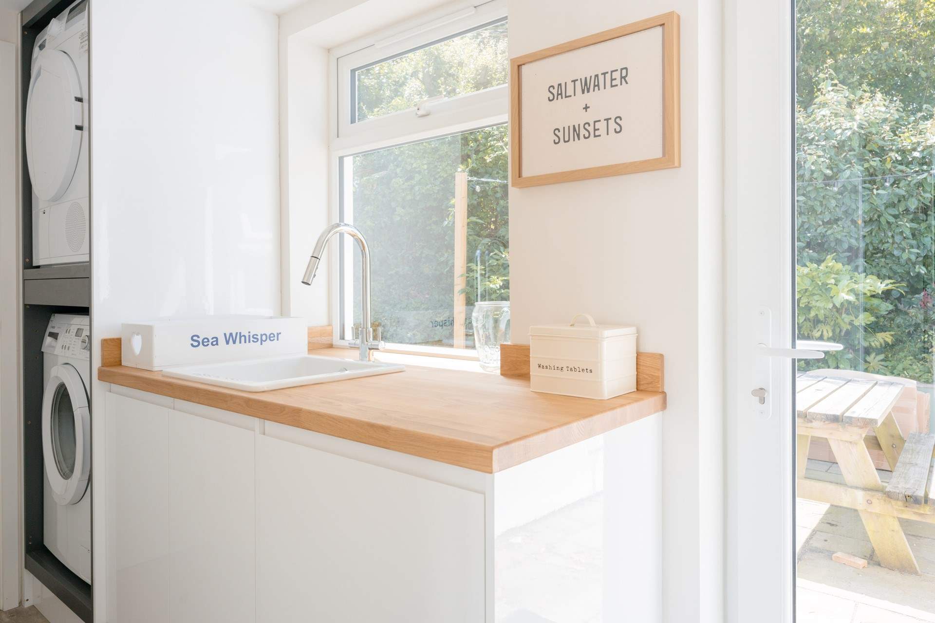 The utility-room houses the washing machine and tumble-drier along with another fridge for drinks.
