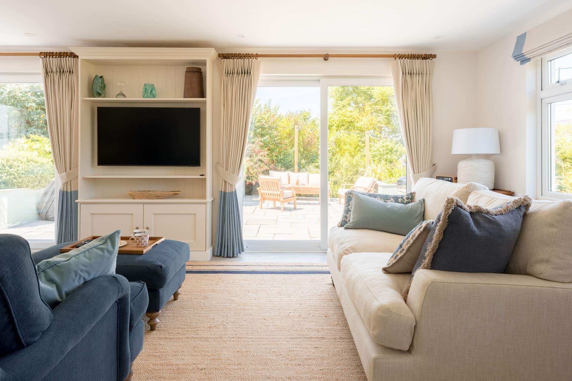 The room floods with light thanks to the patio doors leading out to the side patio where you will find the hot tub and seating-area.
