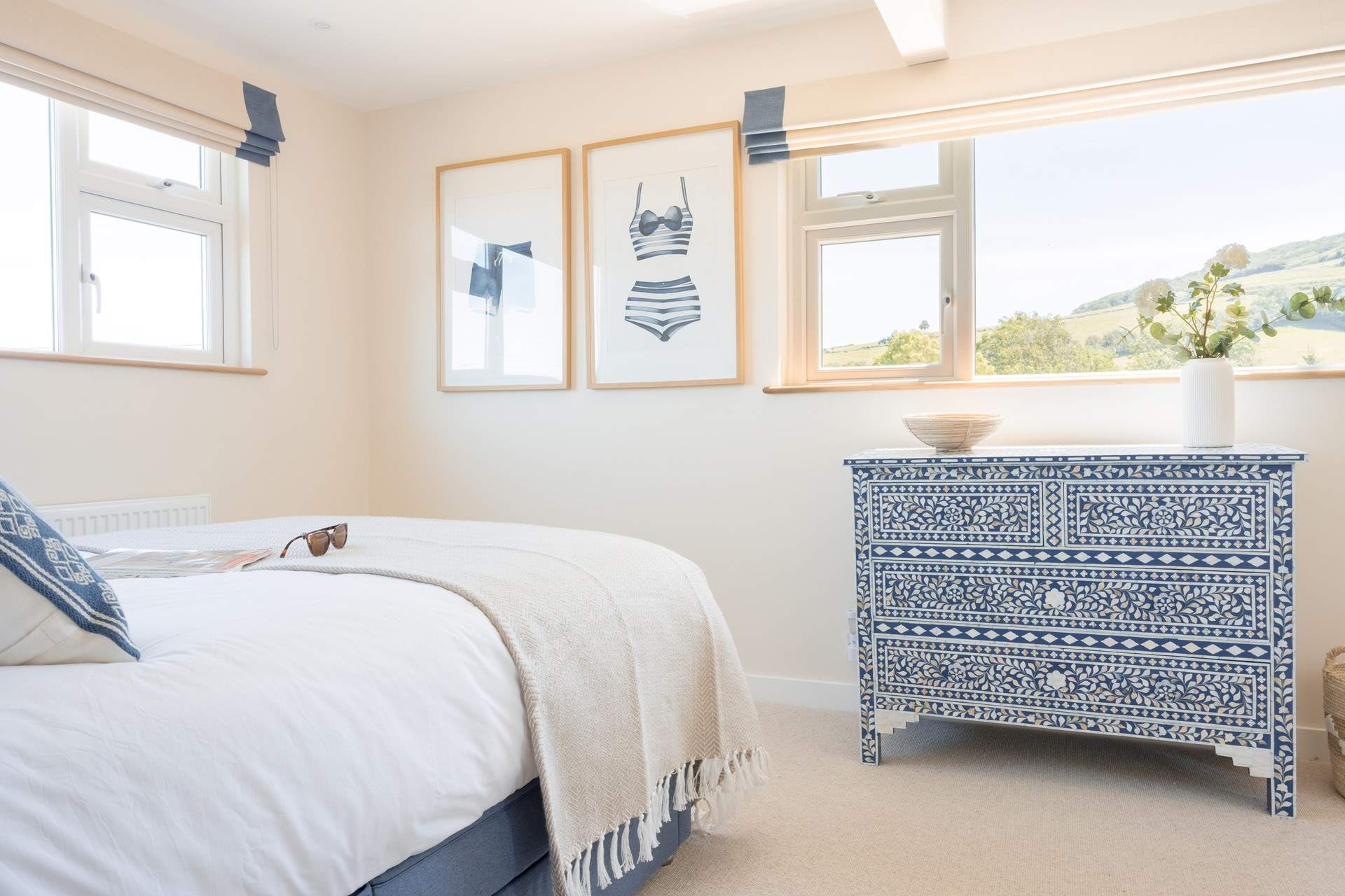 The bedroom floods with light and has views of the rolling fields beyond.