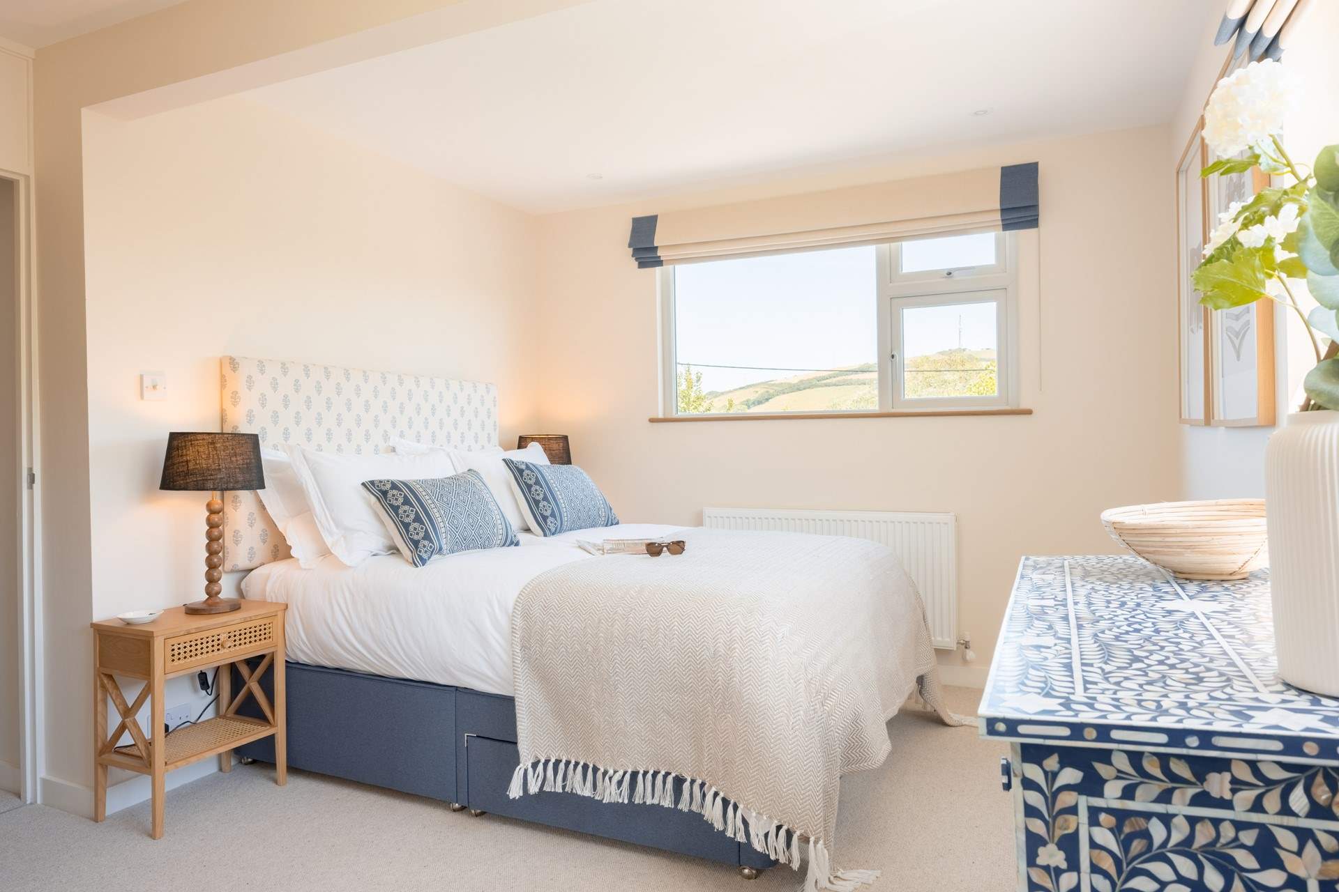 The principal en suite bedroom on the first floor floods with light and enjoys beautiful views.