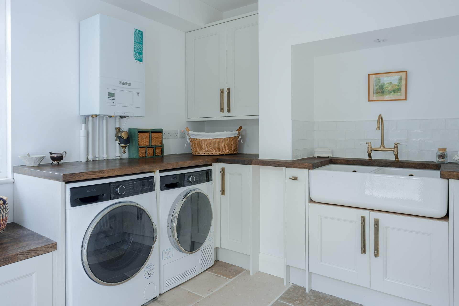 Completing the kitchen is a large separate utility-room with washer, dryer and lots of space for drying/airing. The rear patio also has a pull out line.