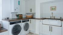 Completing the kitchen is a large separate utility-room with washer, dryer and lots of space for drying/airing. The rear patio also has a pull out line.