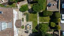 The enclosed grounds of Langmoor House are just as impressive as the interiors. Seen here from above you have a dining-area, lawns, a barbecue-area, shady patio and a sun deck with captivating sea views.