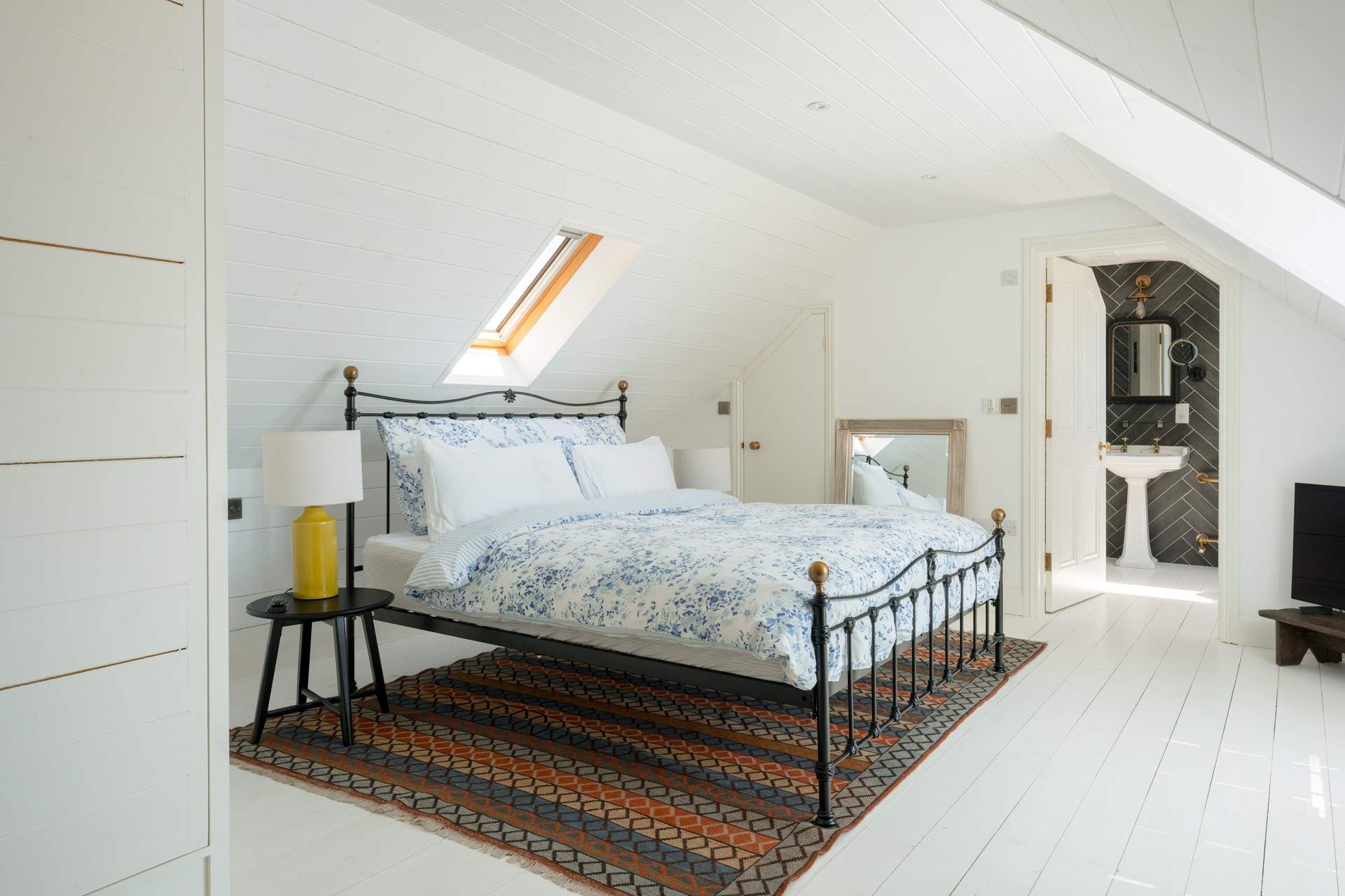 This wonderfully calm and paired back suite has a four-poster super-king bed and plenty of storage.