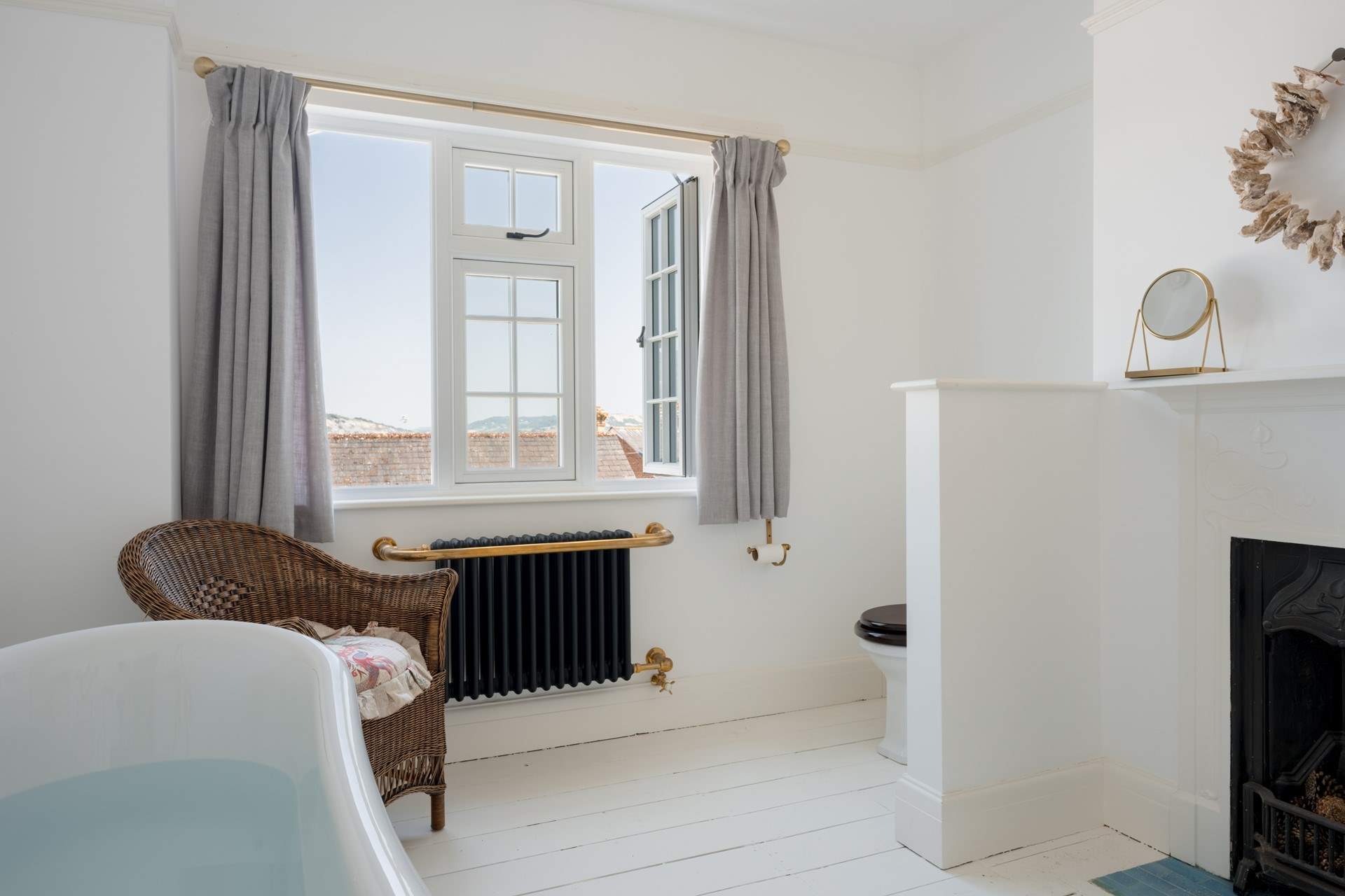 Imagine taking a soak in the deep roll-top bath with sea and rooftop views...